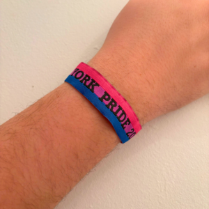 Wrist with a colourful York Pride wristband, representing LGBT+ inclusivity and celebration.